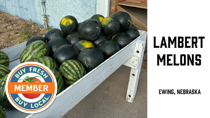Stand holding two varieties of watermelons for sale from Lambert Melons